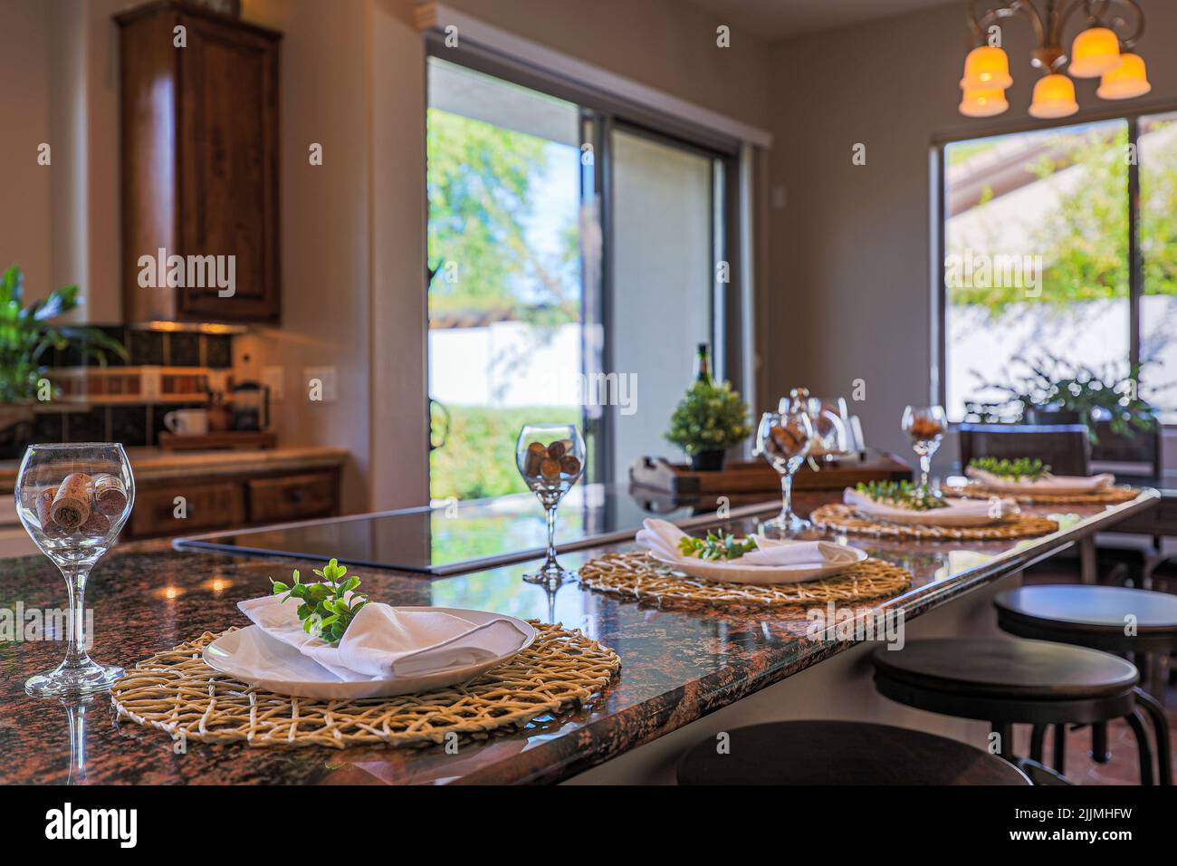 A beautiful interior design of a kitchen with a set dining table Stock