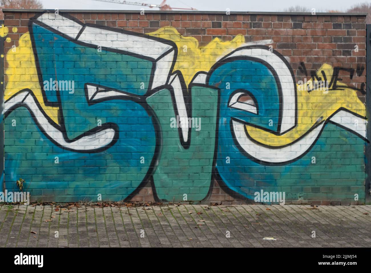 A brick wall with graffiti art in Bottrop, Germany Stock Photo