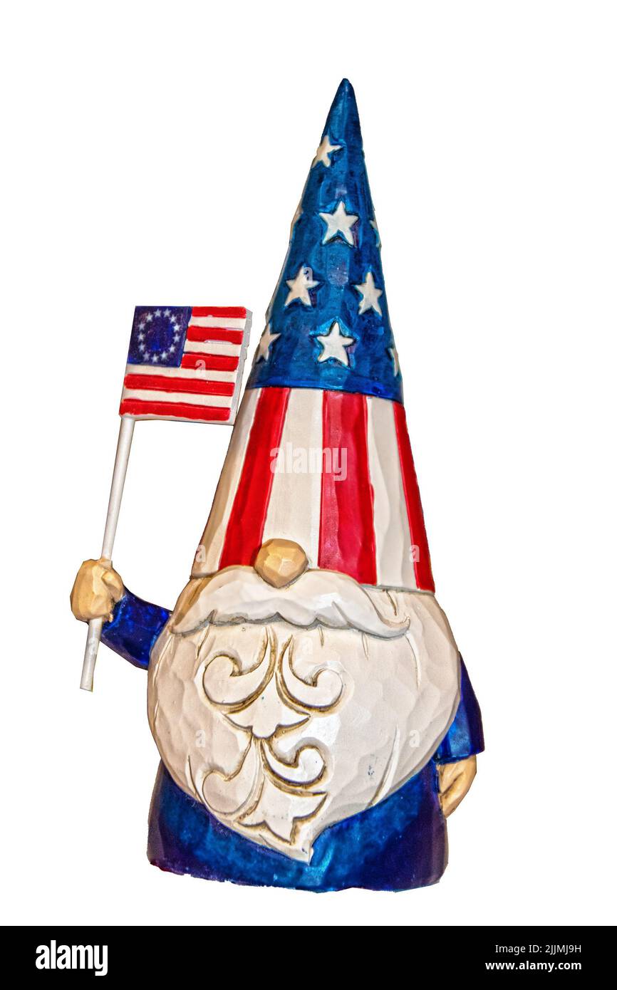 Carved wooden USA Patriotic gnome Christmas ornament waving American Flag isolated on white - Copy Space Stock Photo