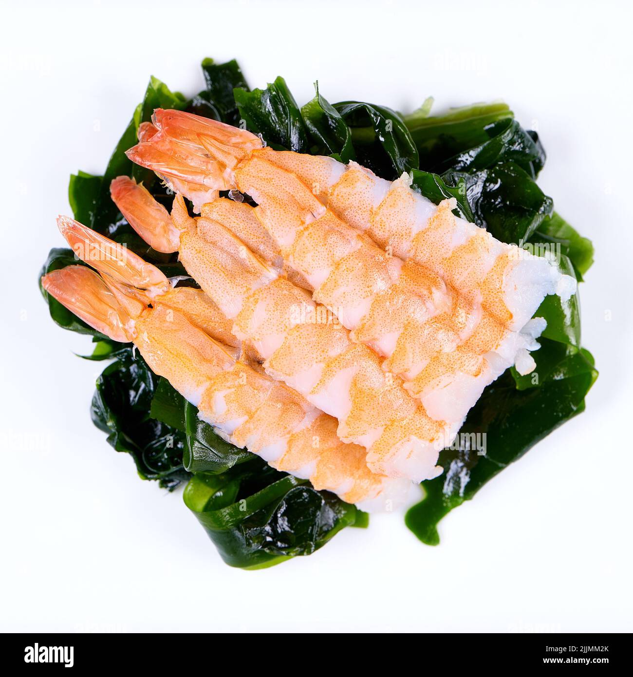 A top view of the shrimps on the wakame on the white background Stock Photo
