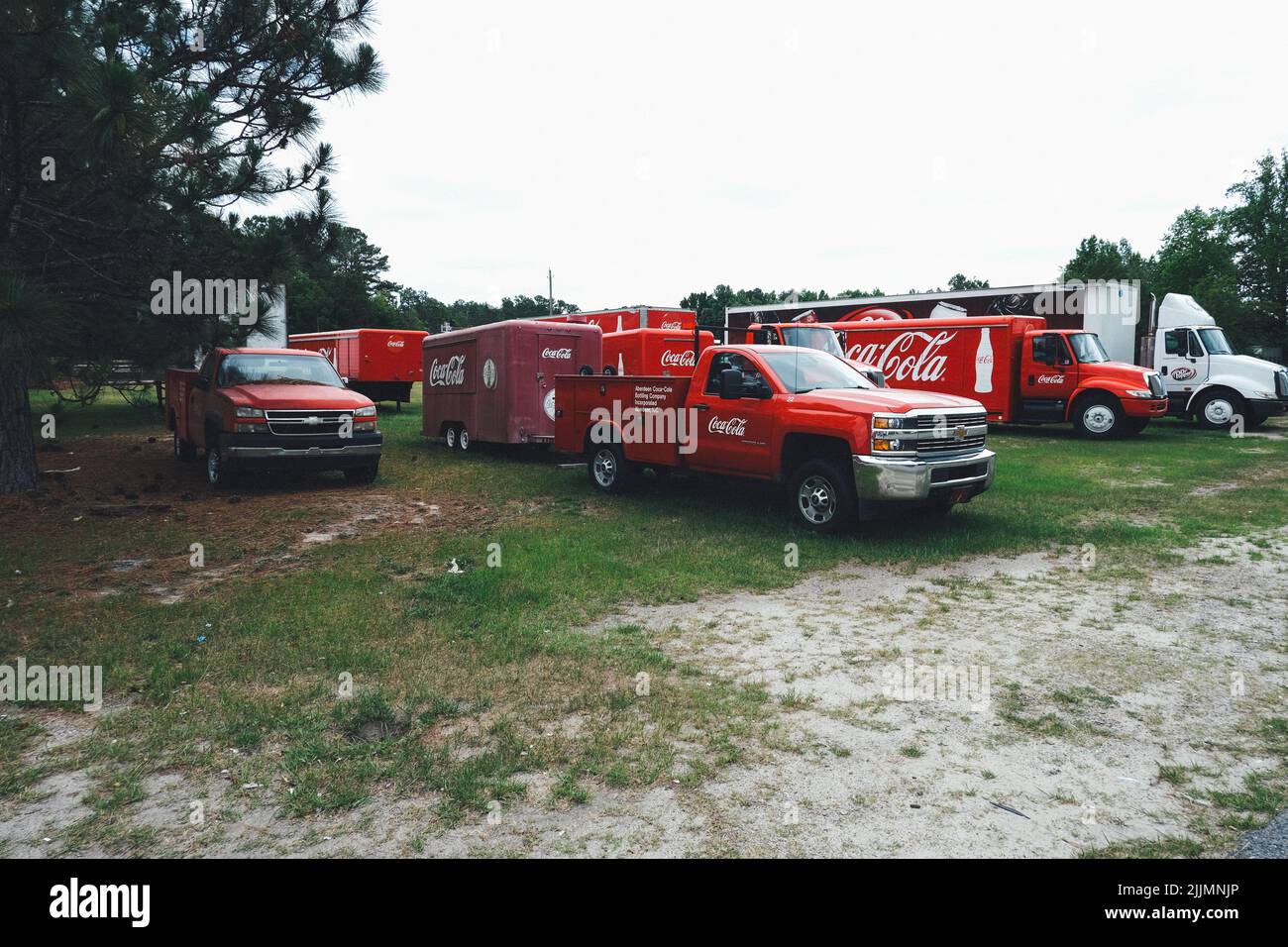 Coca Cola delivery trucks sit in a yard waiting to get to work Stock Photo