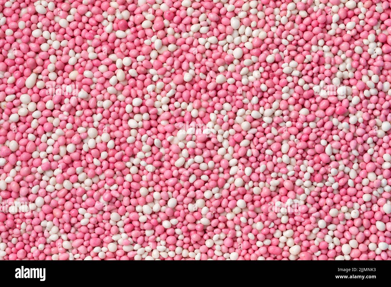 Traditional Dutch pink anise sprinkles to celebrate the birth of a girl full frame close up as background Stock Photo
