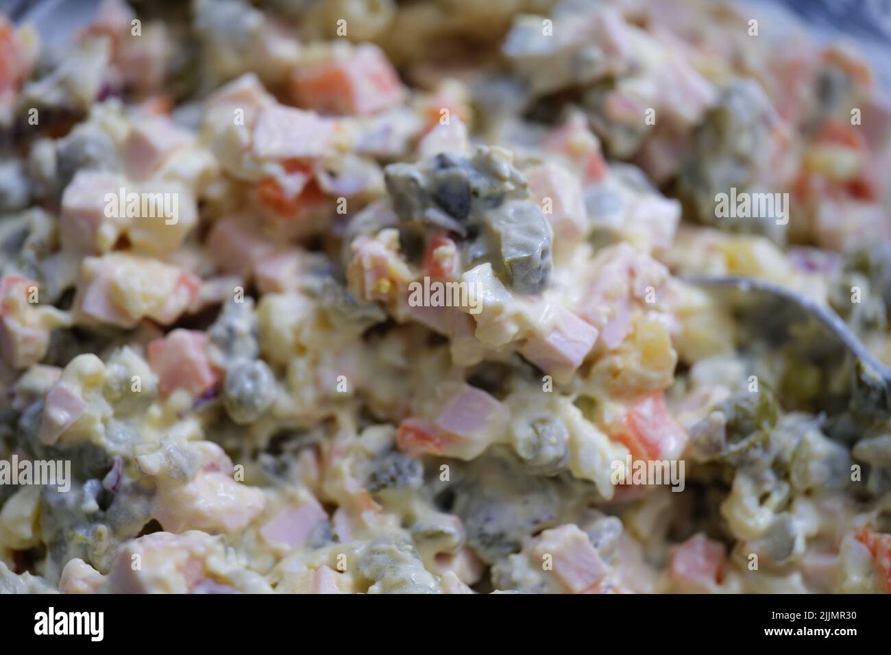 Olivier salad and food ingredients green peas cucumber potatoes sausage and mayonnaise Stock Photo