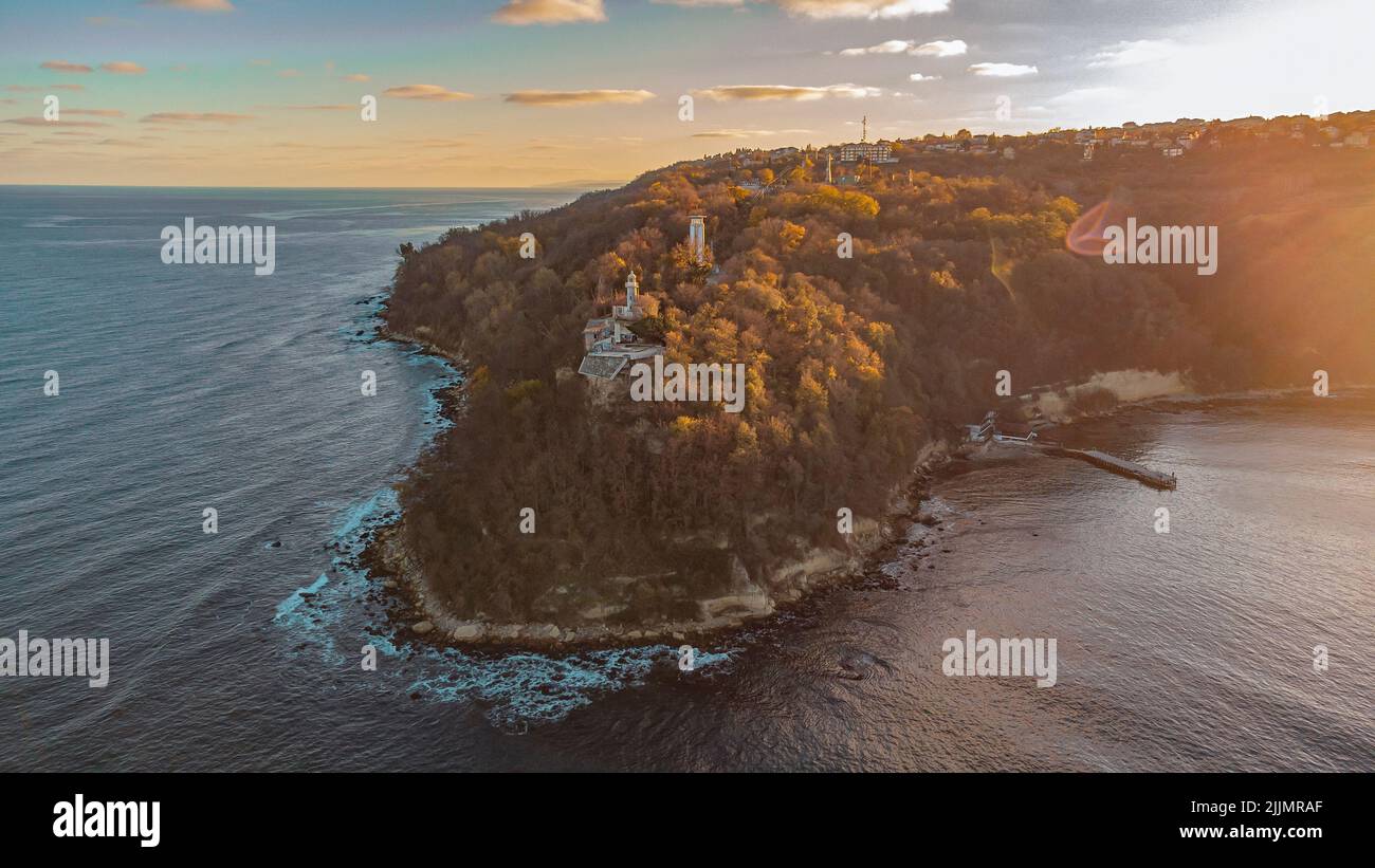 A beautiful shot of some buildings placed on an island hill next to the sea. Stock Photo