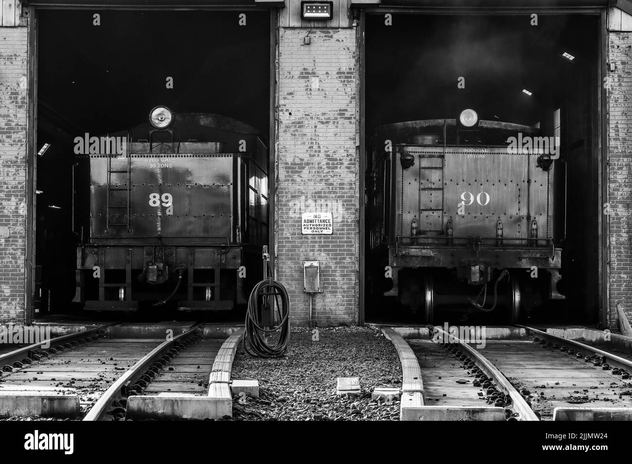 A grayscale view of train engines 89 and 90 in the shed at Strasburg Railroad, United States Stock Photo