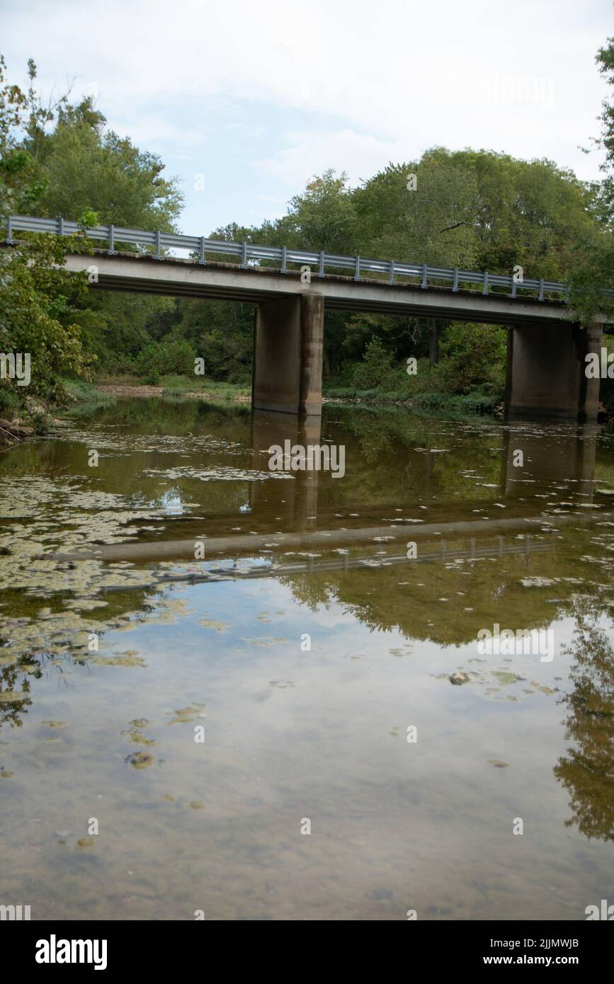 a photo of a small bridge over small river Stock Photo