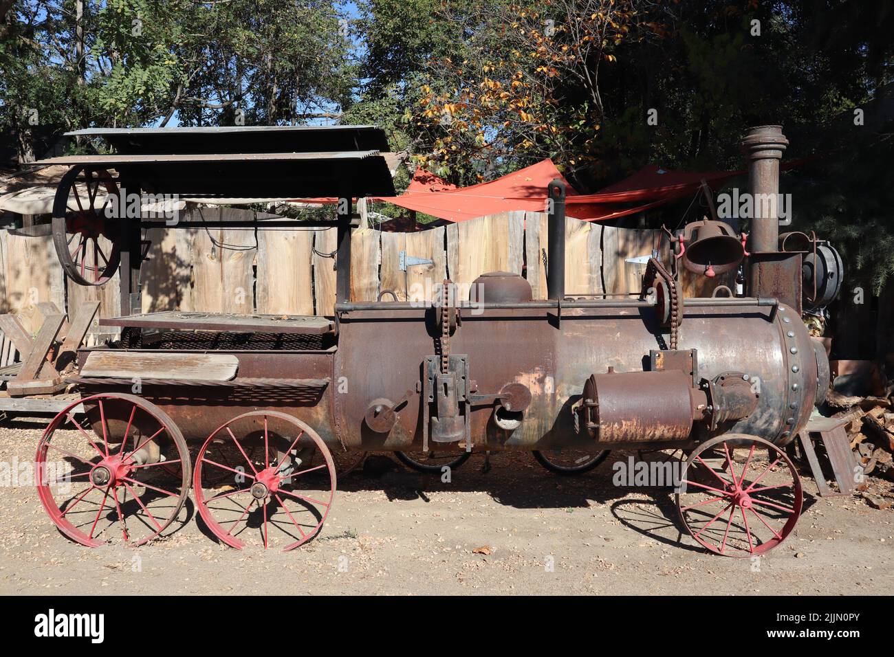 A vintage rustic tractor turned into a barbecue grill and smoker Stock