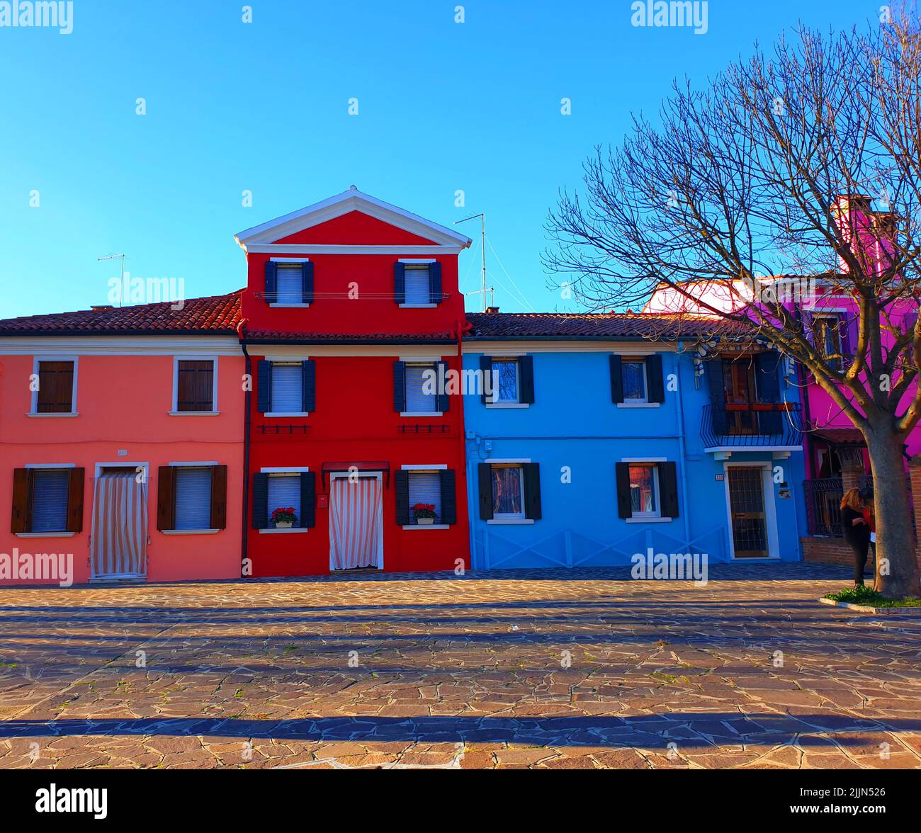 A low-angle shot of colorful painted houses on Burano island, Venice, Italy Stock Photo