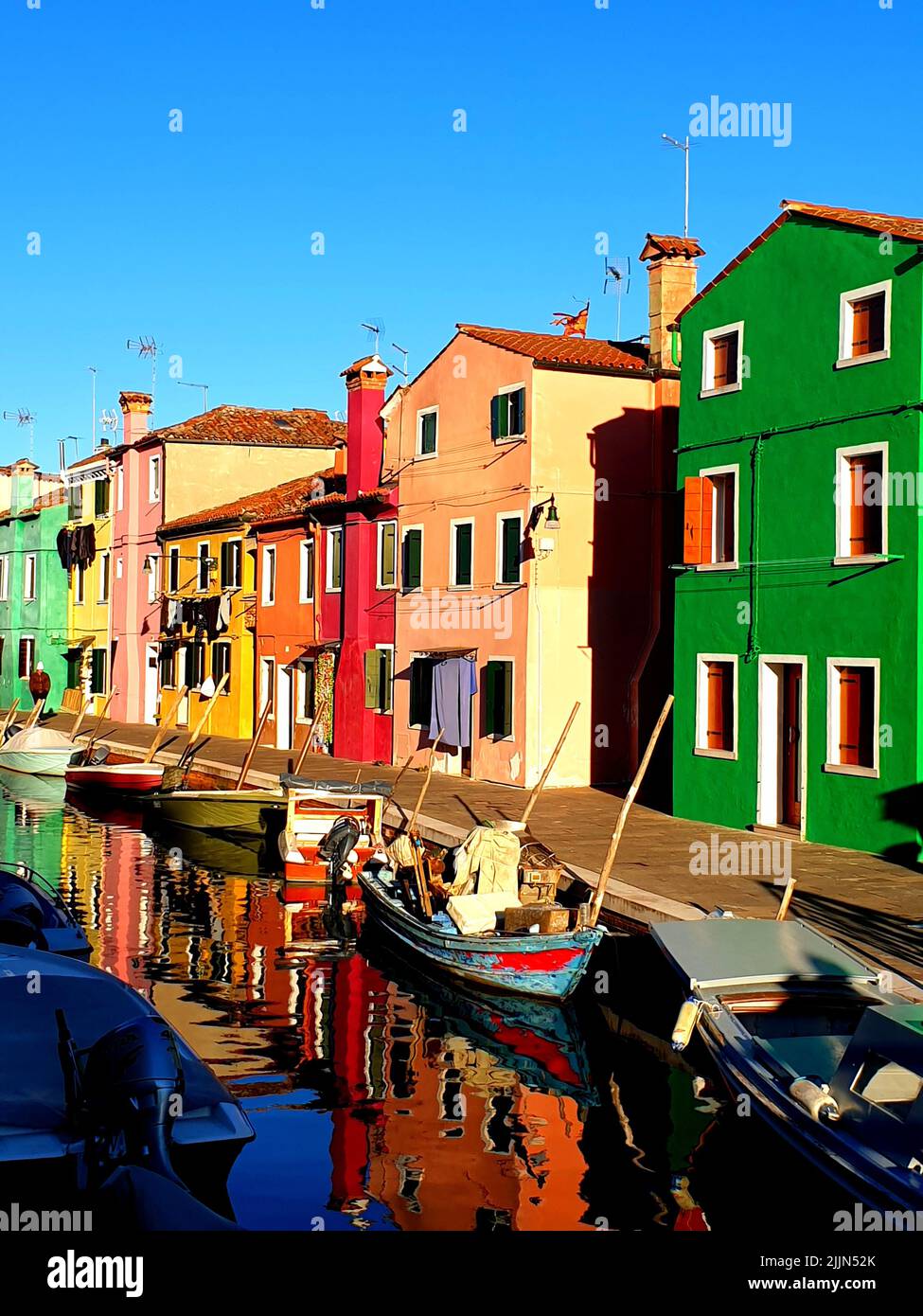 A low-angle shot of colorful painted houses on Burano island, Venice, Italy Stock Photo