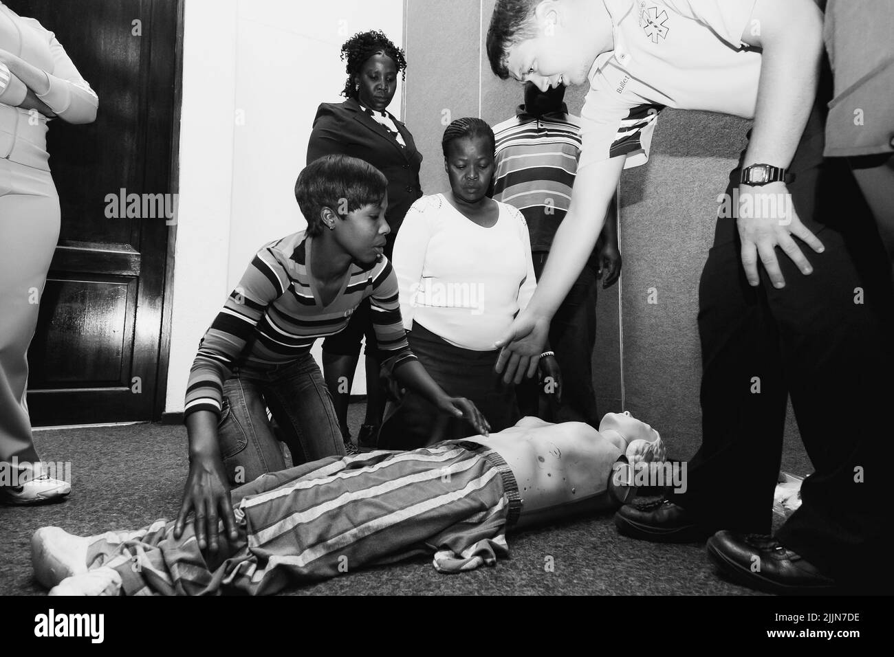A grayscale of the First Aid CPR training with a plastic dummy in Johannesburg, South Africa Stock Photo