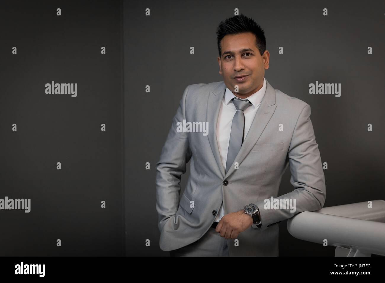 A portrait of tech billionaire Priven Reddy on a gray background Stock Photo