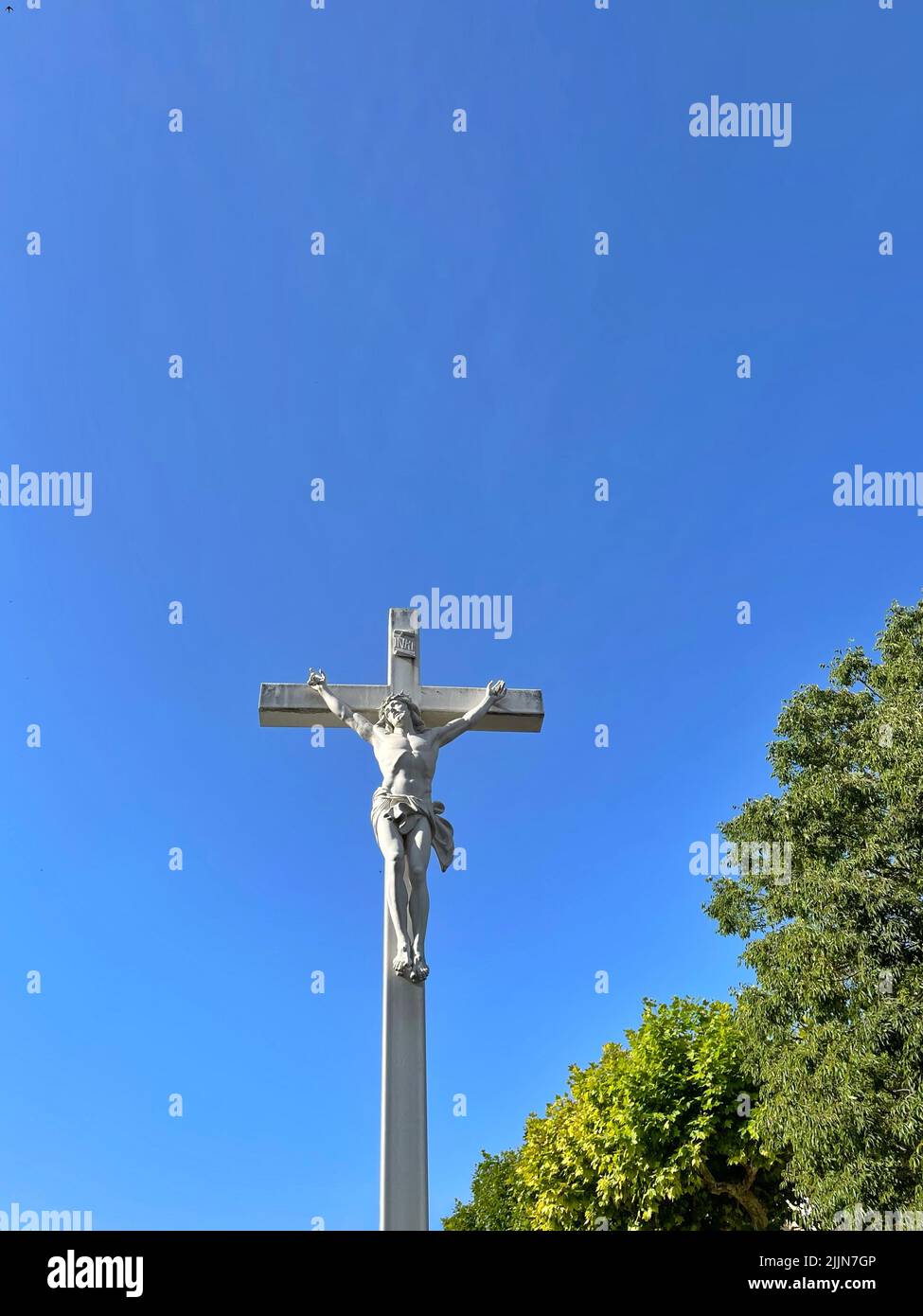 Crucifix in the town square, Maussane-les-Alpilles, Bouches-du-Rhone, Provence-Alpes-Cote-d'Azur, France Stock Photo
