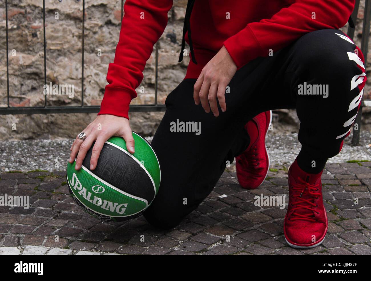 A male model wearing fashionable Air Jordan shoes and sweatpants for a photoshoot Stock Photo