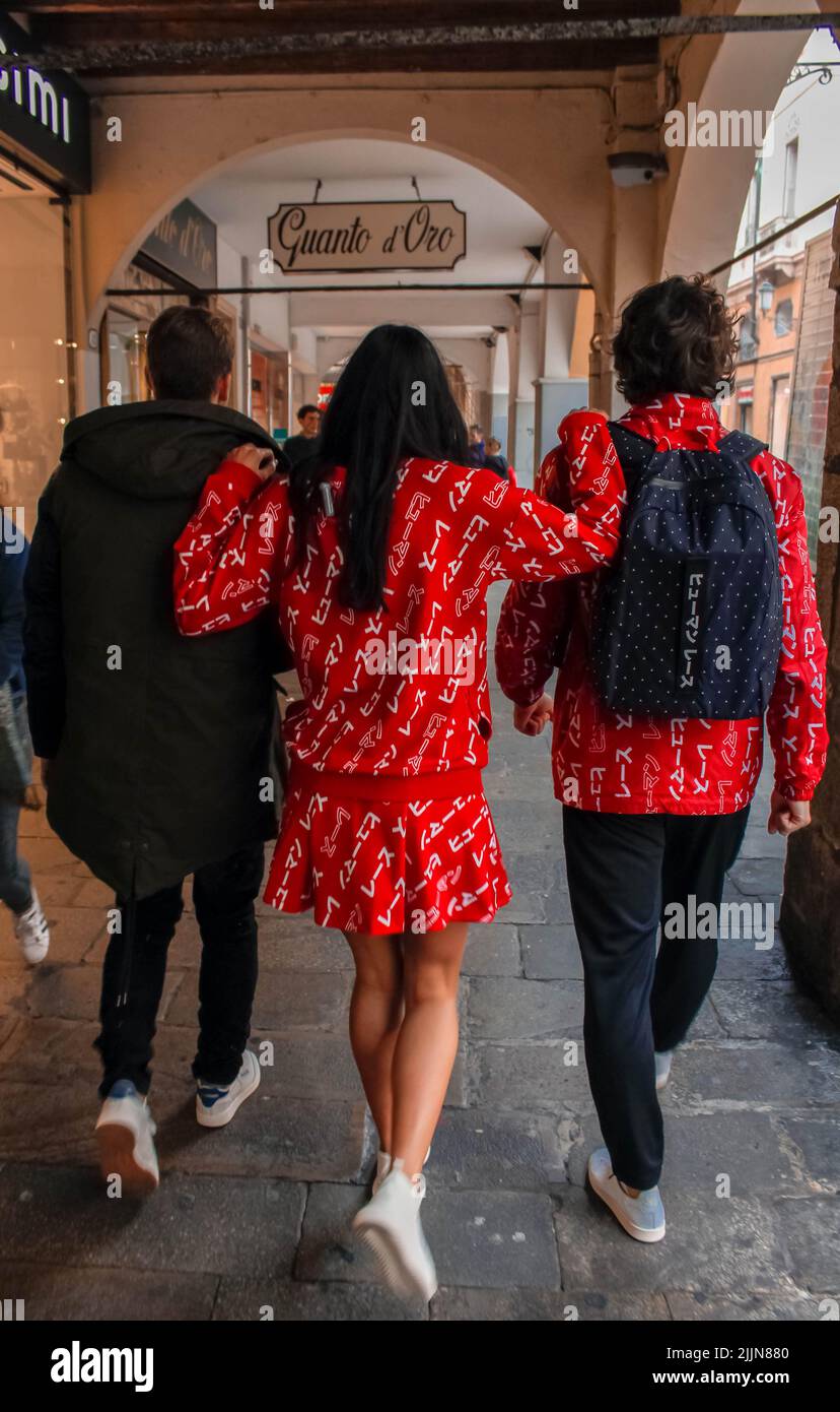 A back view of a group of friends walking on the street wearing stylish clothes Stock Photo