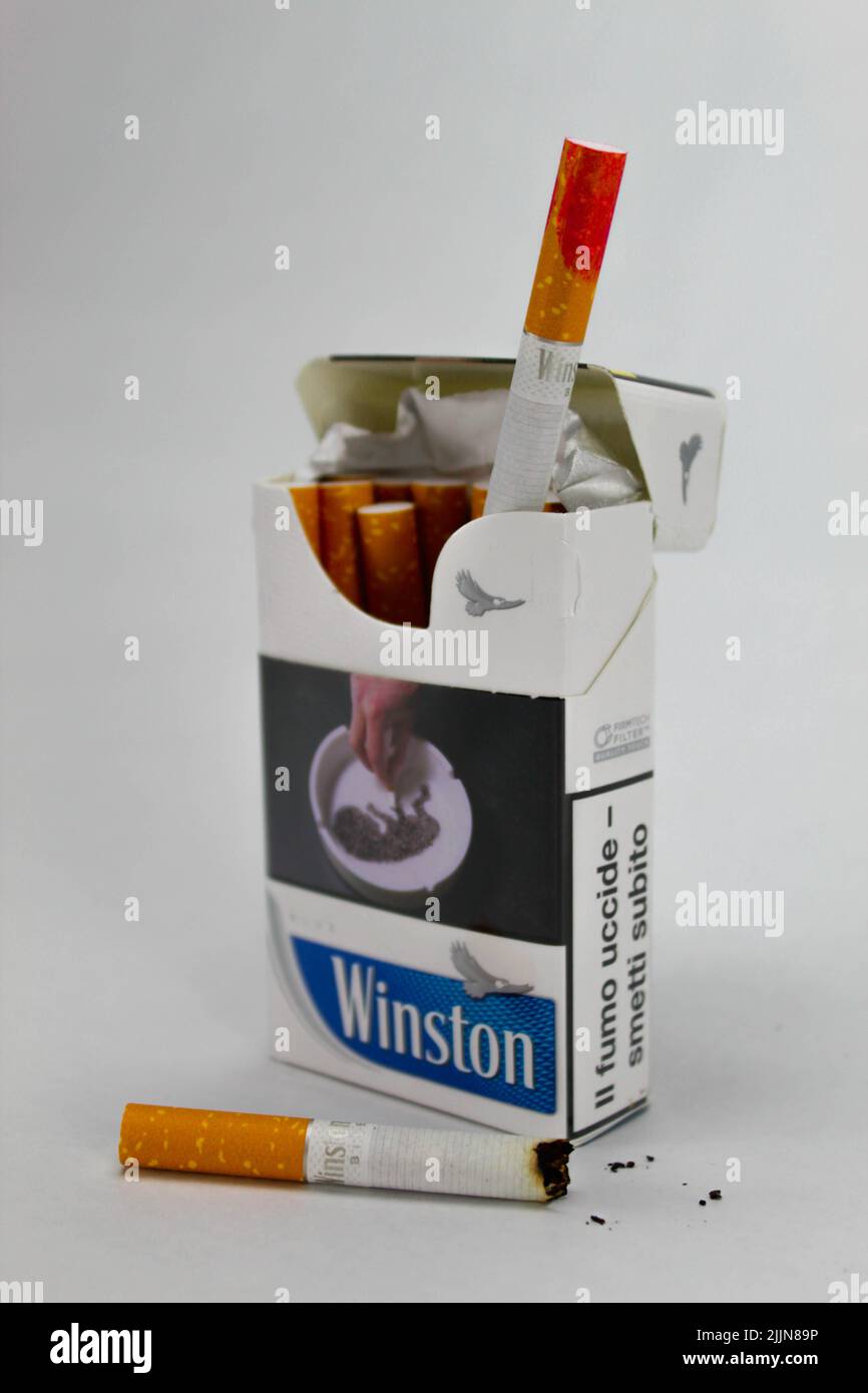 A closeup of a pack of Winston cigarettes with a red lipstick stain against the white background Stock Photo