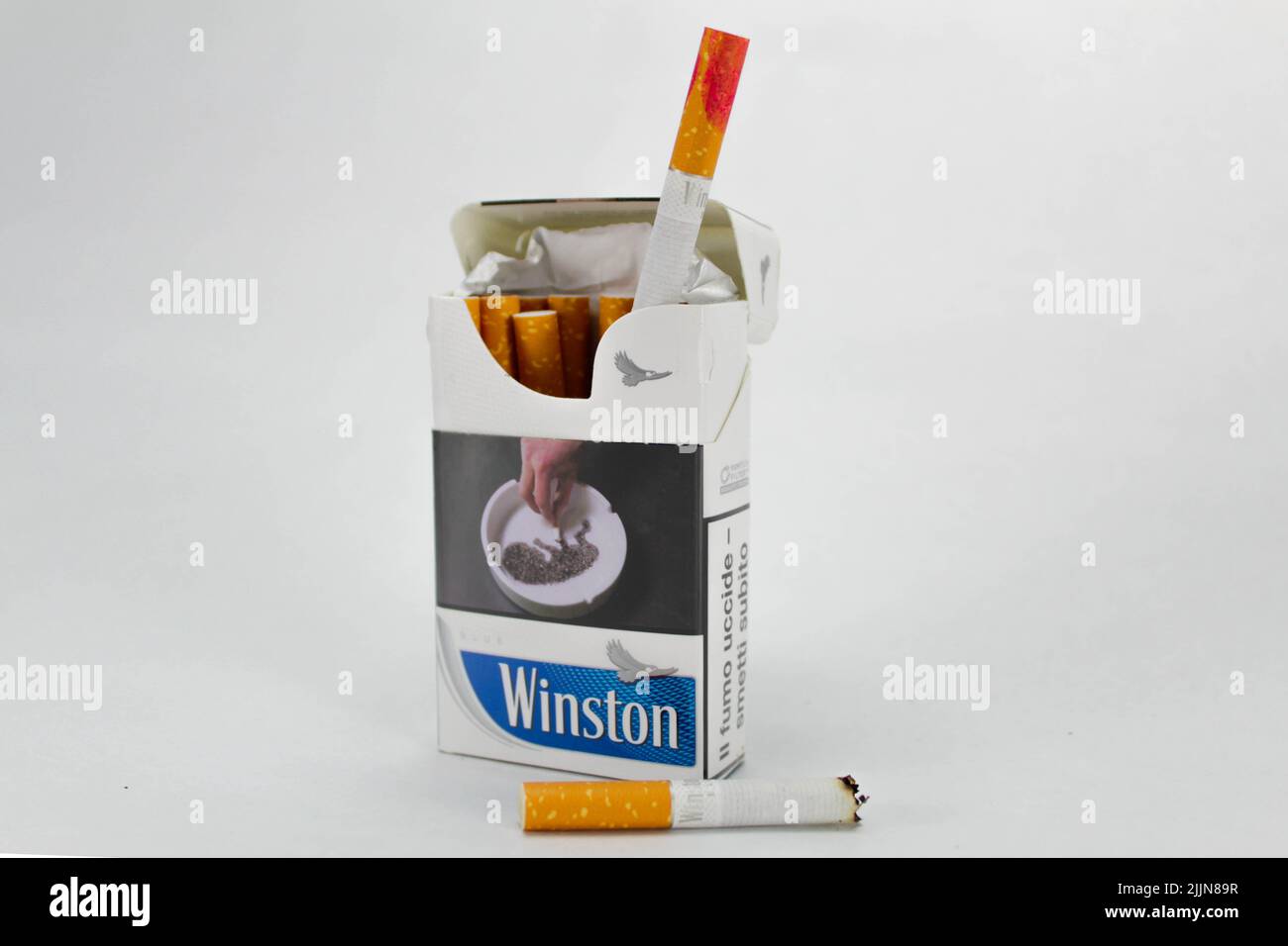 A closeup of a pack of Winston cigarettes with a red lipstick stain against the white background Stock Photo