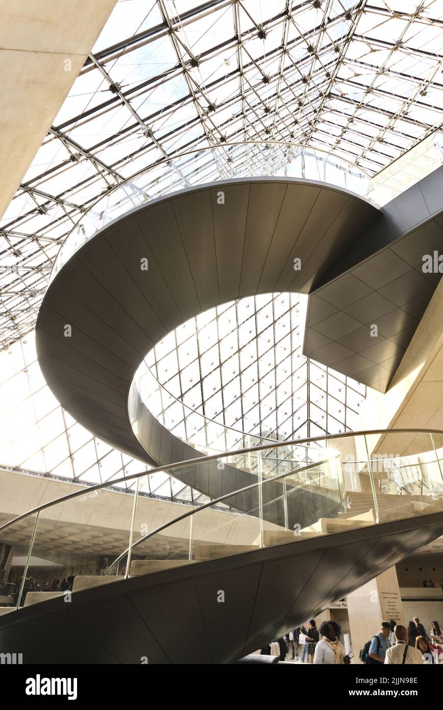 The Top part of the glass pyramid and the stairway in the main lobby at the Louvre Museum, Paris, France Stock Photo