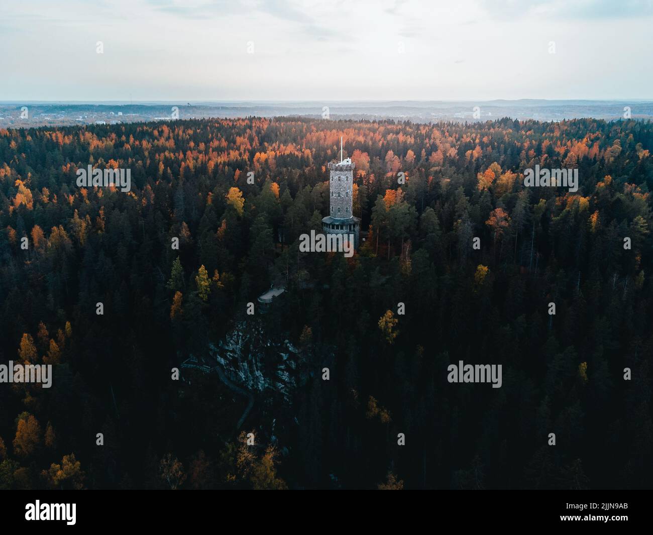 An aerial view of Aulanko tower in Hameenlinna, Finland surrounded by forests in autumn Stock Photo