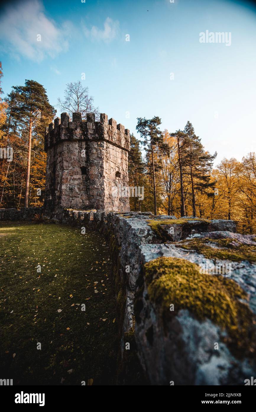 A low angle shot of Aulanko castle surrounded by autumn trees in daylight Stock Photo
