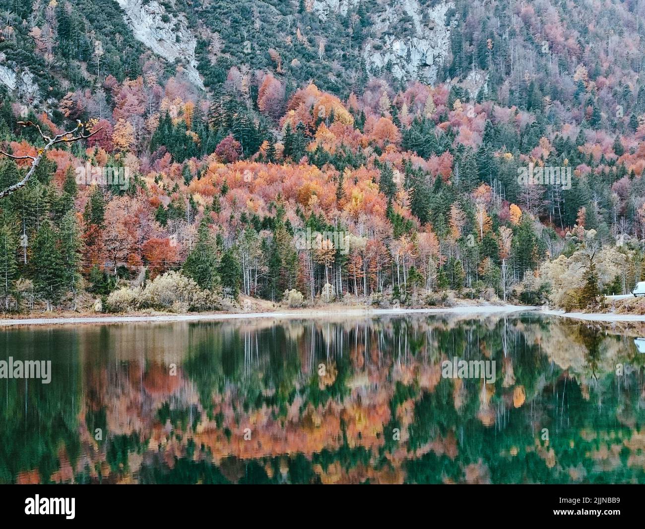 The mountain lake shot with autumn tree reflections on a water Stock ...