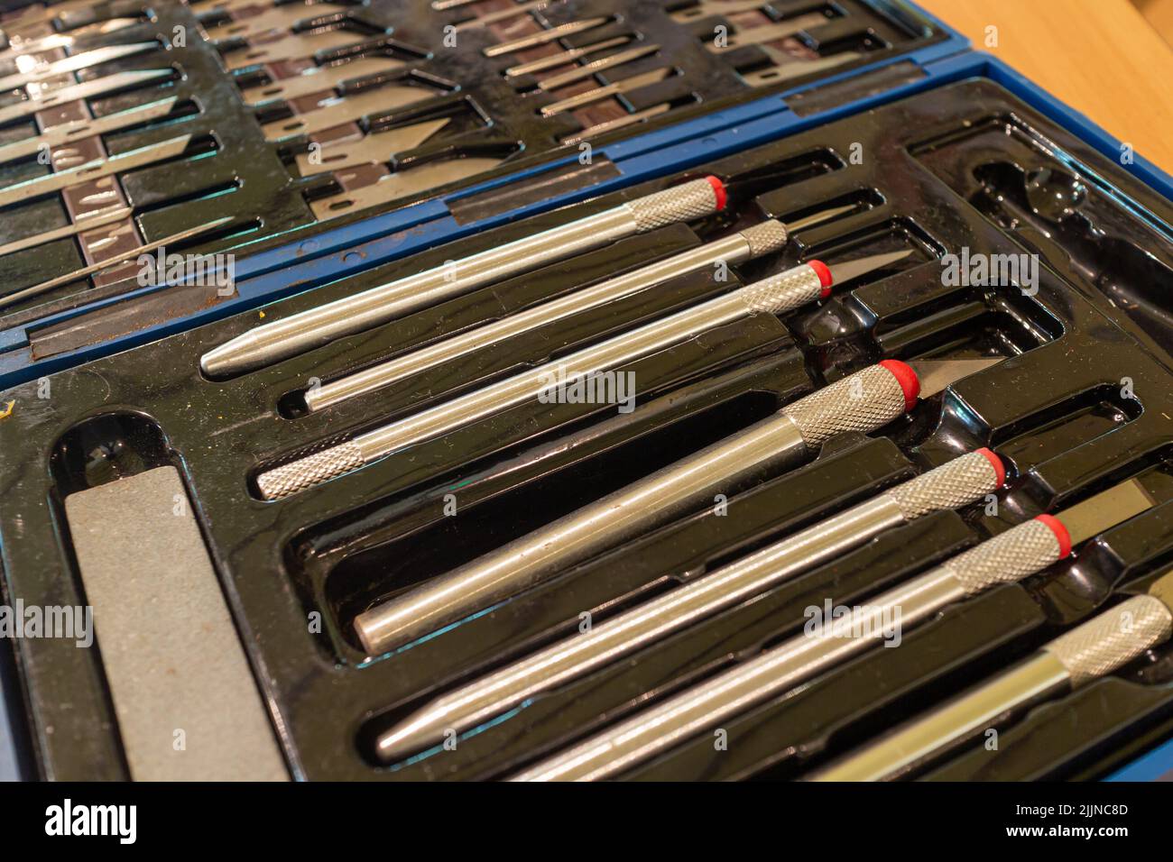 Various sharp precision craft knives with different blades in a customized storage box Stock Photo