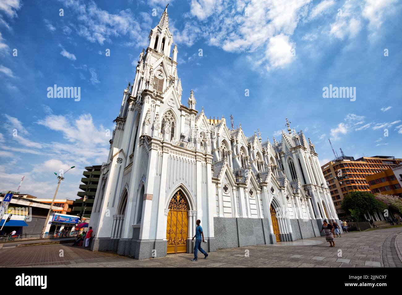 The people walking past the gothic La Ermita Church in Cali, Colombia Stock Photo