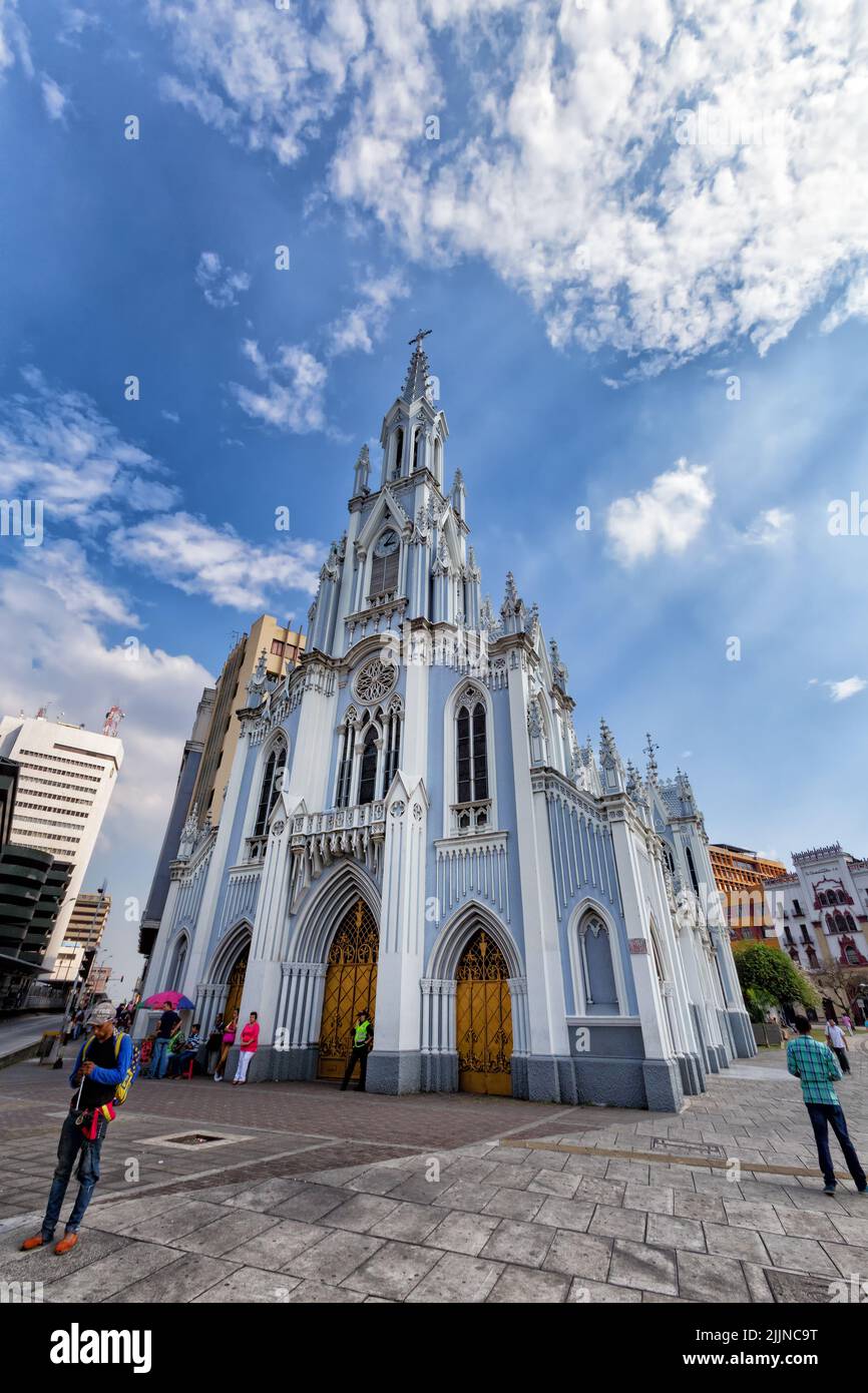The Portrait view of people walking past the gothic La Ermita Church in Cali, Colombia Stock Photo