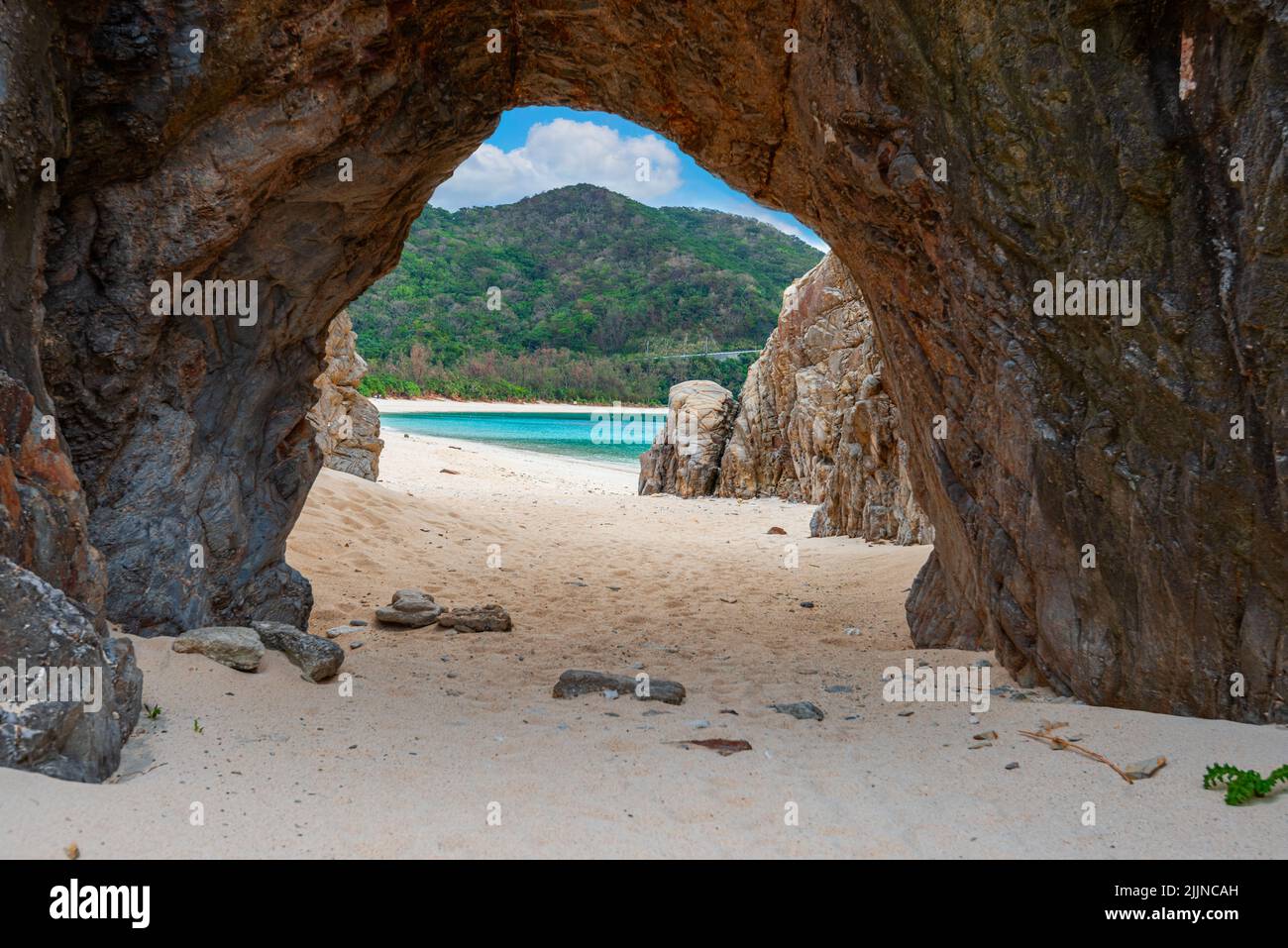 okashiki Island, Okinawa, Japan at Aharen Beach and the natural stone arch. Stock Photo