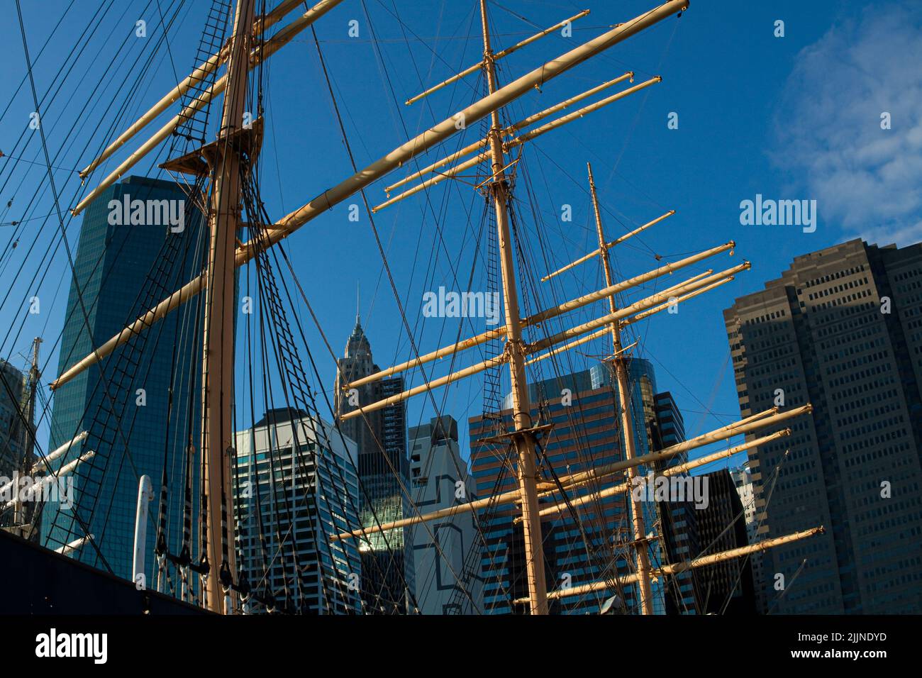 The  Mast of The Historic Ship ' Peking'  With The Modern Buildings of Lower Manhattan in The Background, South Street Seaport Museum, New York, New Y Stock Photo
