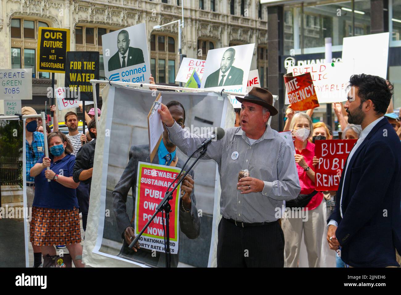 A speaker is seen chanting in front of the City Hall in New York City demanding public renewables for climate justice on July 27, 2022. Stock Photo
