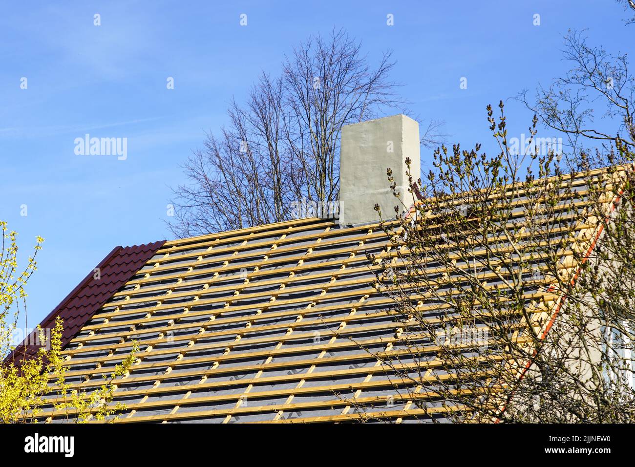 Workers on town house roof removing old slates / no safety equipment or  helmets - France Stock Photo - Alamy