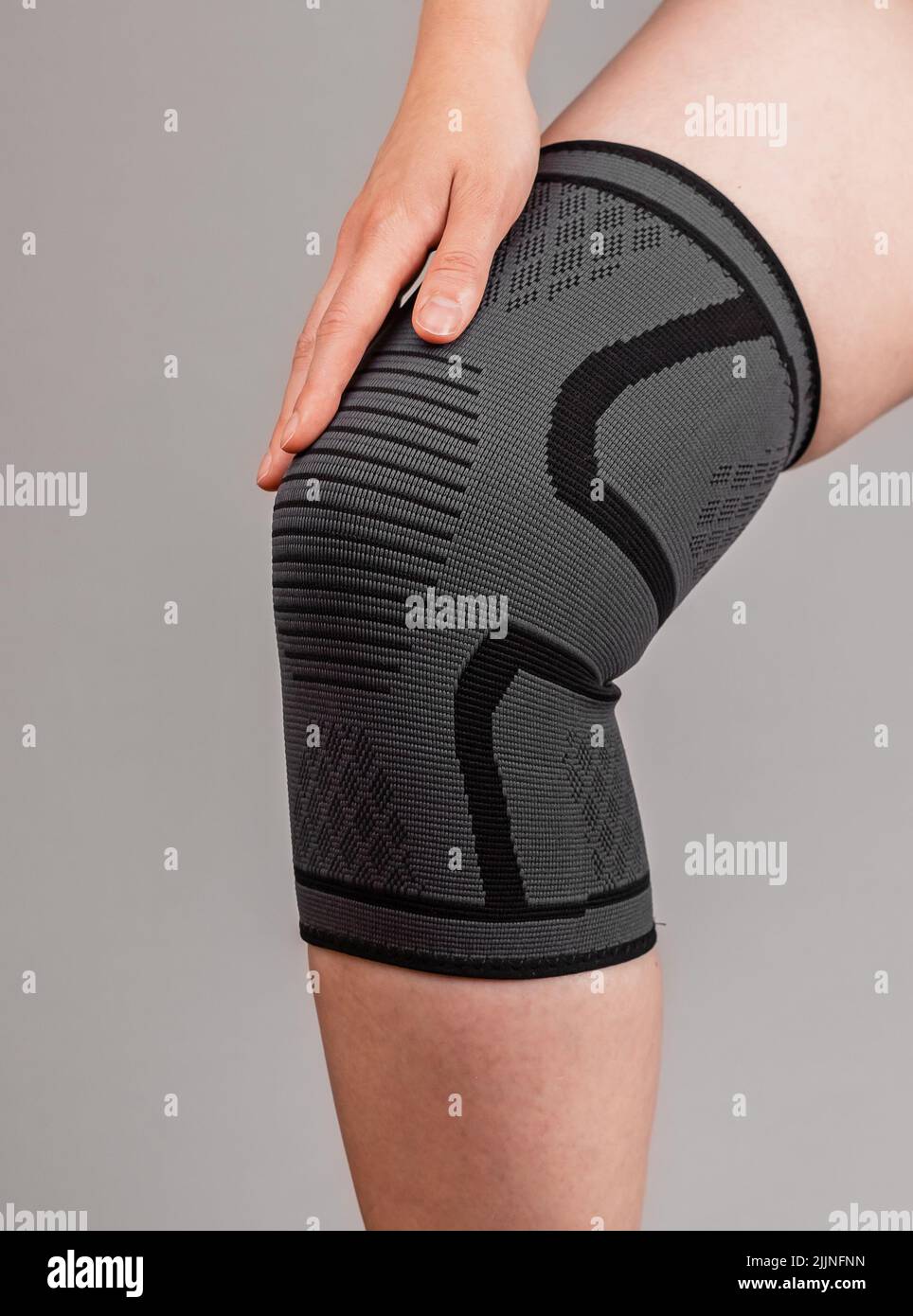 Woman wearing knee pad to reduce pain. Sprained, ruptured ligaments