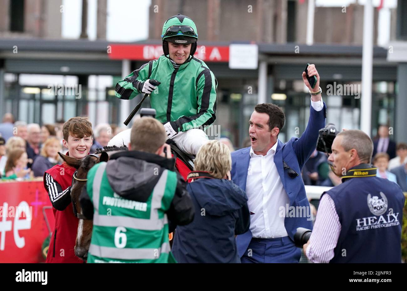 Hewick with owner TJ McDonald and Jockey Jordan Gainford in the parade ring after winning the The Tote Galway Plate during day three of the Galway Races Summer Festival 2022 at Galway Racecourse in County Galway, Ireland. Picture date: Wednesday July 27, 2022. Stock Photo
