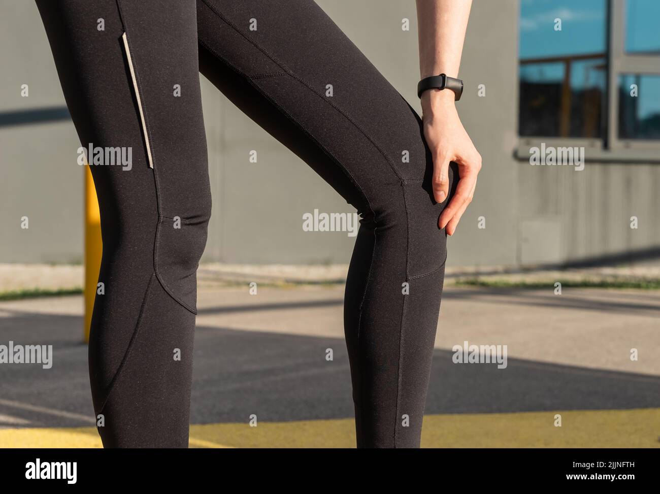 Athlete suffering from knee pain. Woman touching painful leg. Sprained