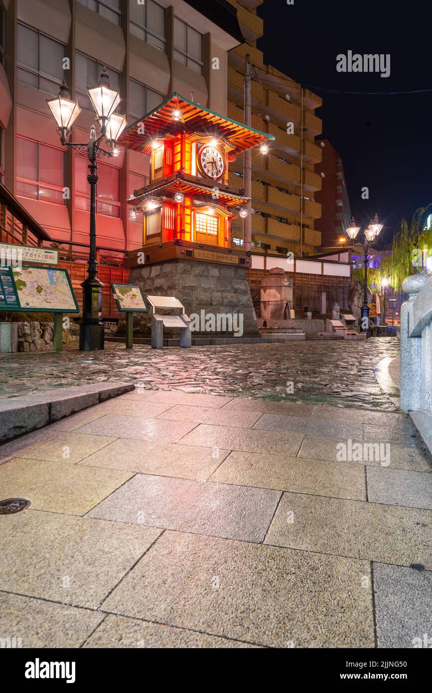 Dogo Onsen, Matsuyama, Japan at the historic clock. (Sign in Japanese reading 'Yokoso Dogo Onsen e' translates in English to 'Welcome to Dogo Hot Spri Stock Photo