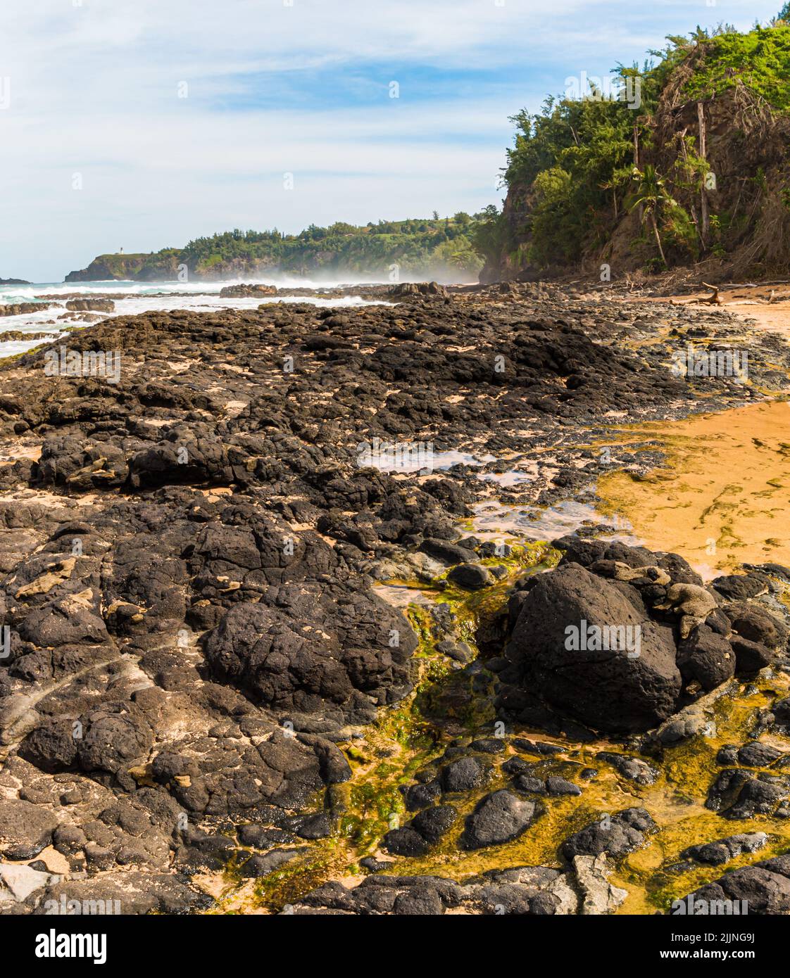 Waves Crash Over Exposed Coral Reef at Kauapea Beach, Kauai, Hawaii