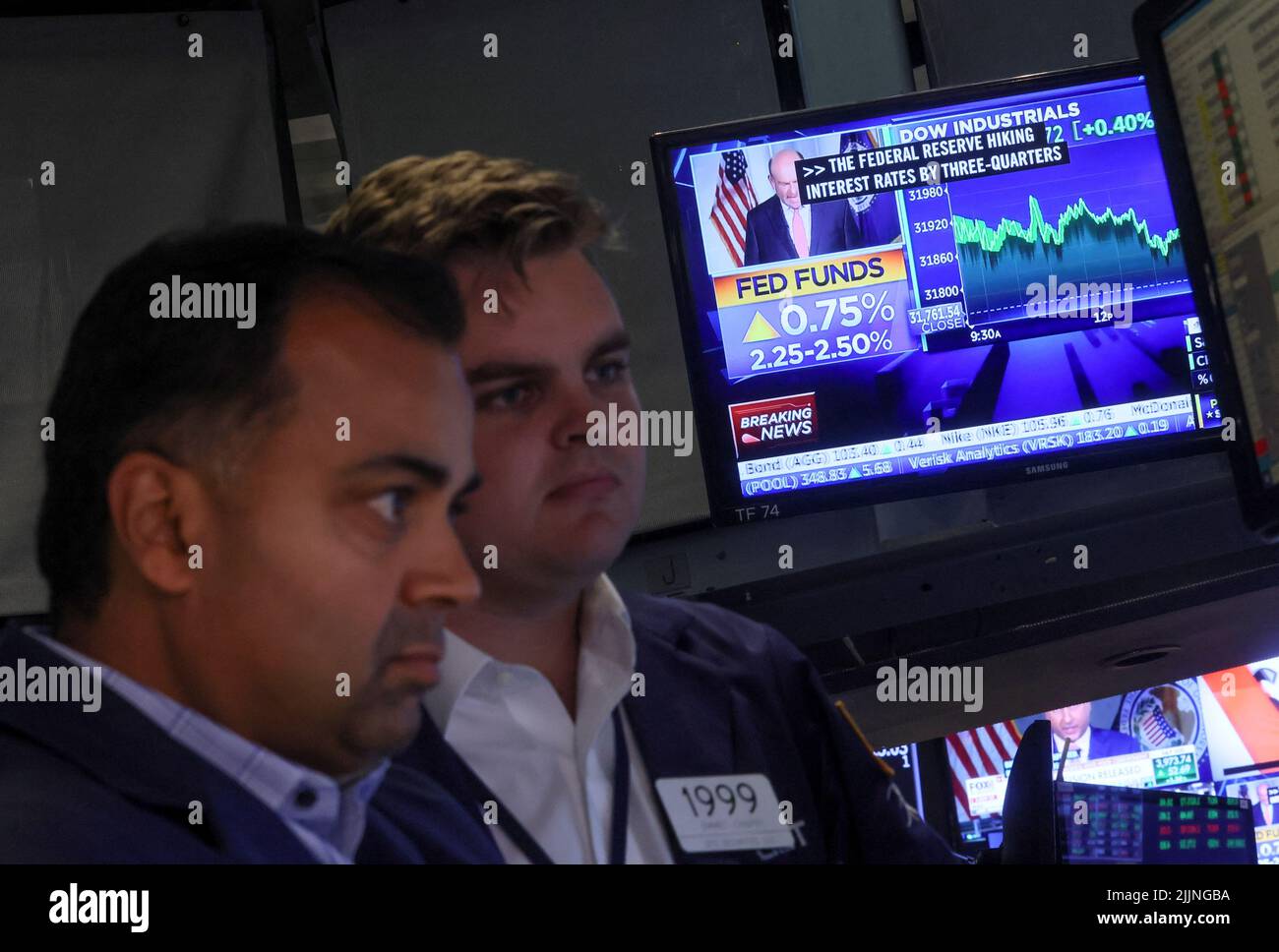 A screen displays the Fed rate announcement as traders react on the floor of the New York Stock Exchange (NYSE) in New York City, U.S., July 27, 2022. REUTERS/Brendan McDermid Stock Photo