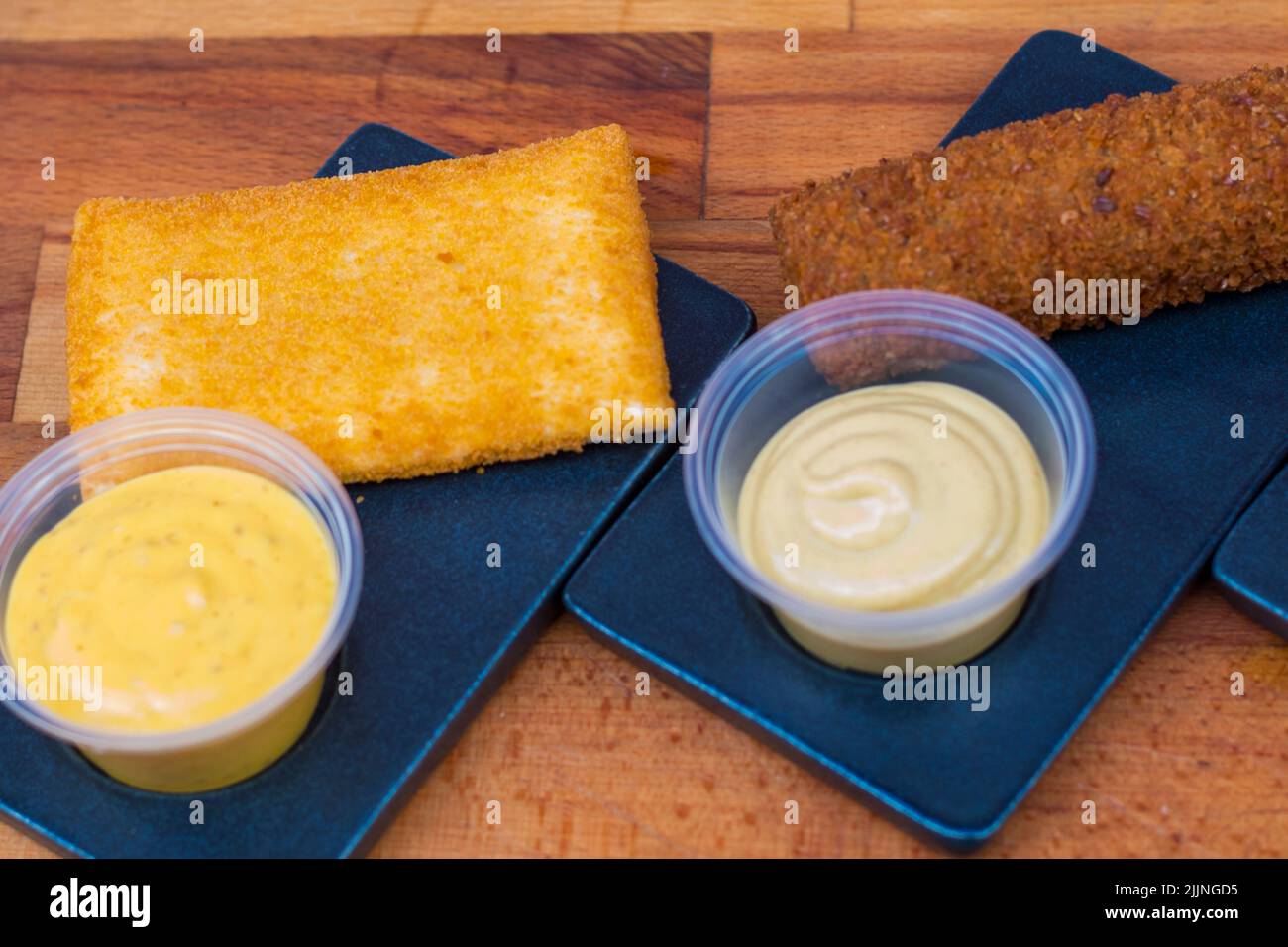 A top view of two types of the deepfried crispy nuggets with sauces
