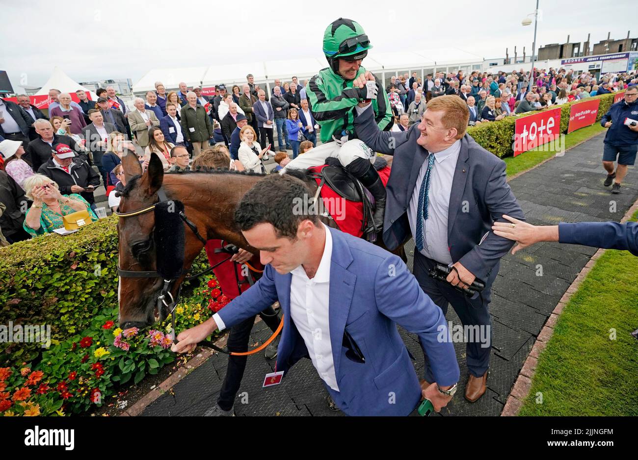 Hewick's trainer John Hanlon celebrates with Jockey Jordan Gainford in the parade ring after winning the The Tote Galway Plate during day three of the Galway Races Summer Festival 2022 at Galway Racecourse in County Galway, Ireland. Picture date: Wednesday July 27, 2022. Stock Photo