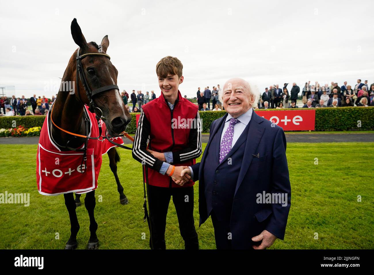 President Michael D Higgins congratulates groom Paddy Hanlon after Hewick won The Tote Galway Plate during day three of the Galway Races Summer Festival 2022 at Galway Racecourse in County Galway, Ireland. Picture date: Wednesday July 27, 2022. Stock Photo