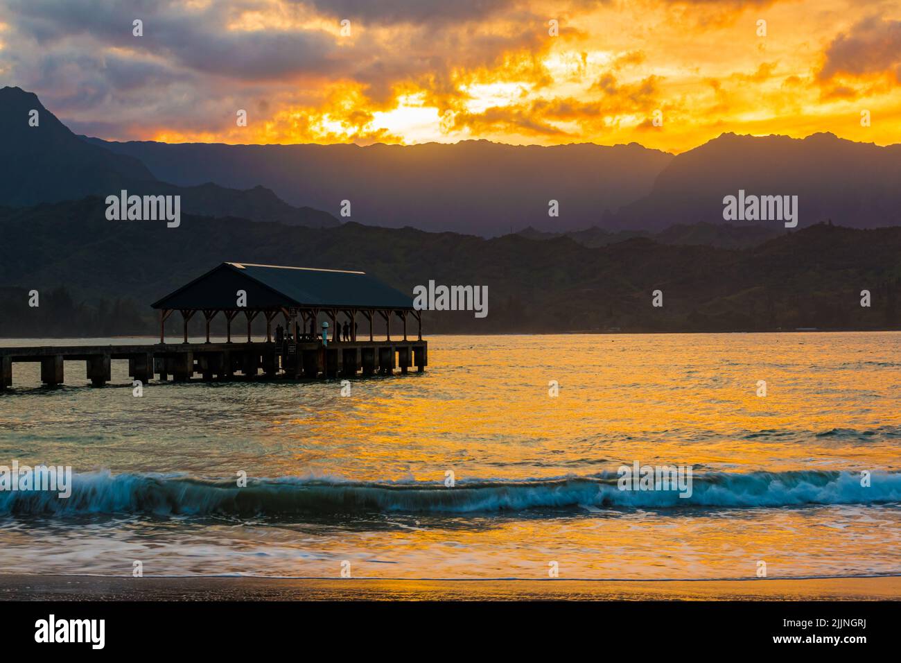 Hanalei Pier and Hanalei Bay at Sunset, Black Pots Beach Park, Kauai, Hawaii, USA Stock Photo
