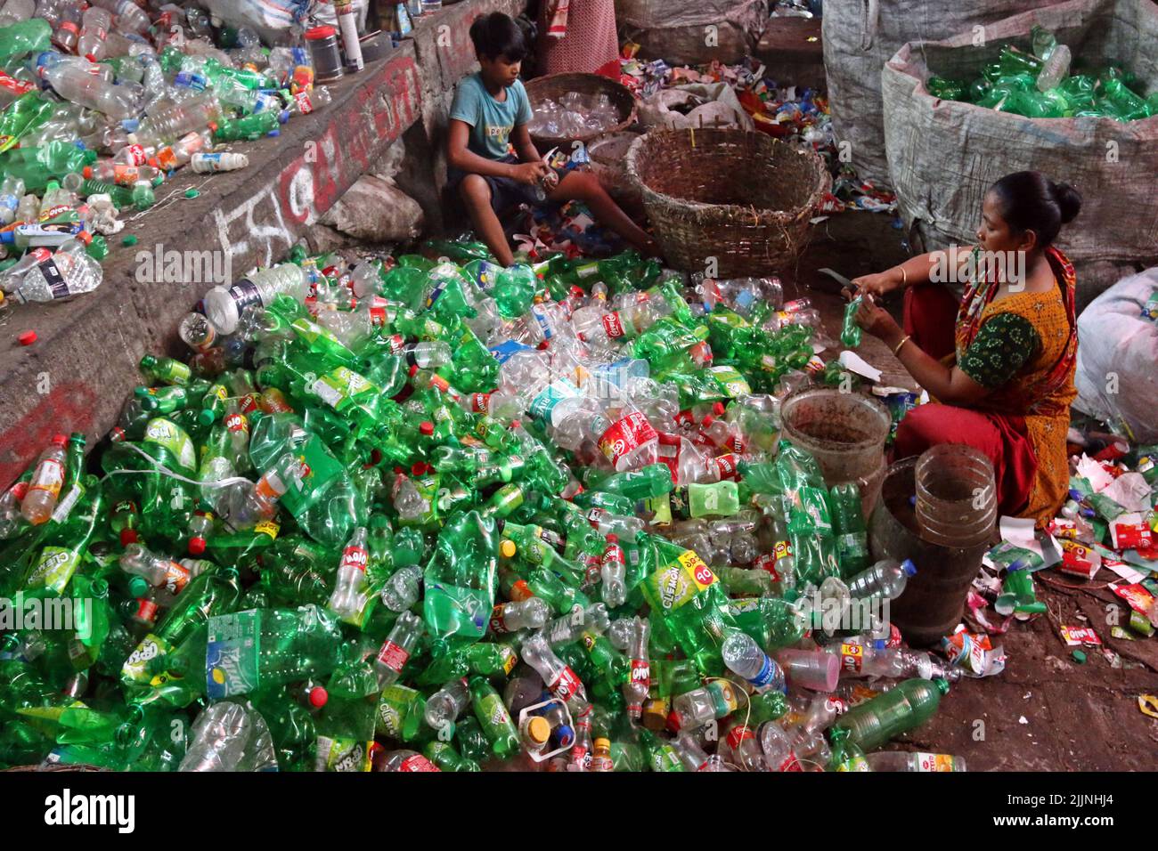 Workers are seen in a plastic bottle recycling factory in Dhaka