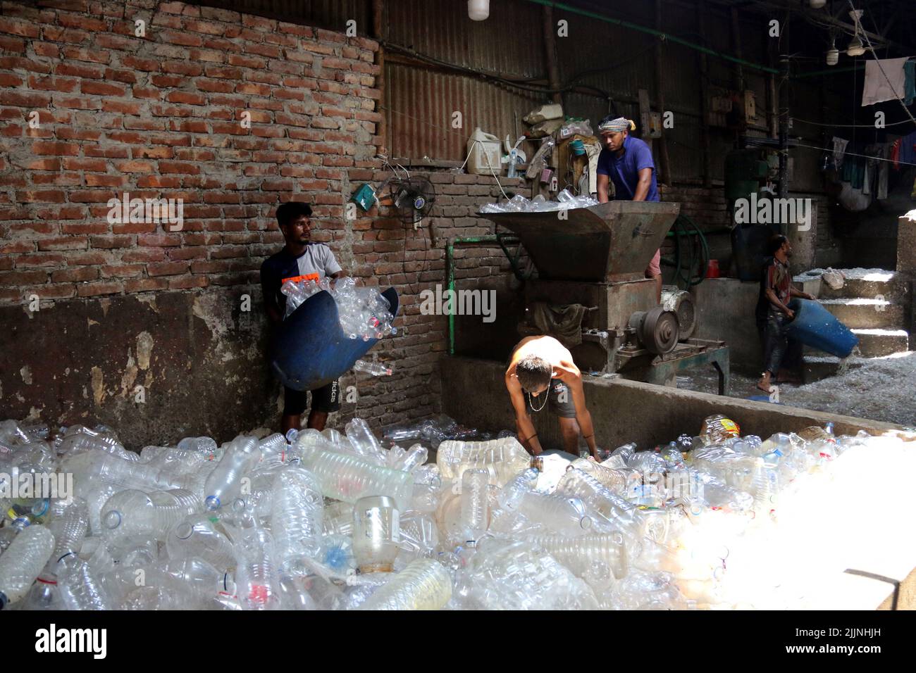 Workers are seen in a plastic bottle recycling factory in Dhaka