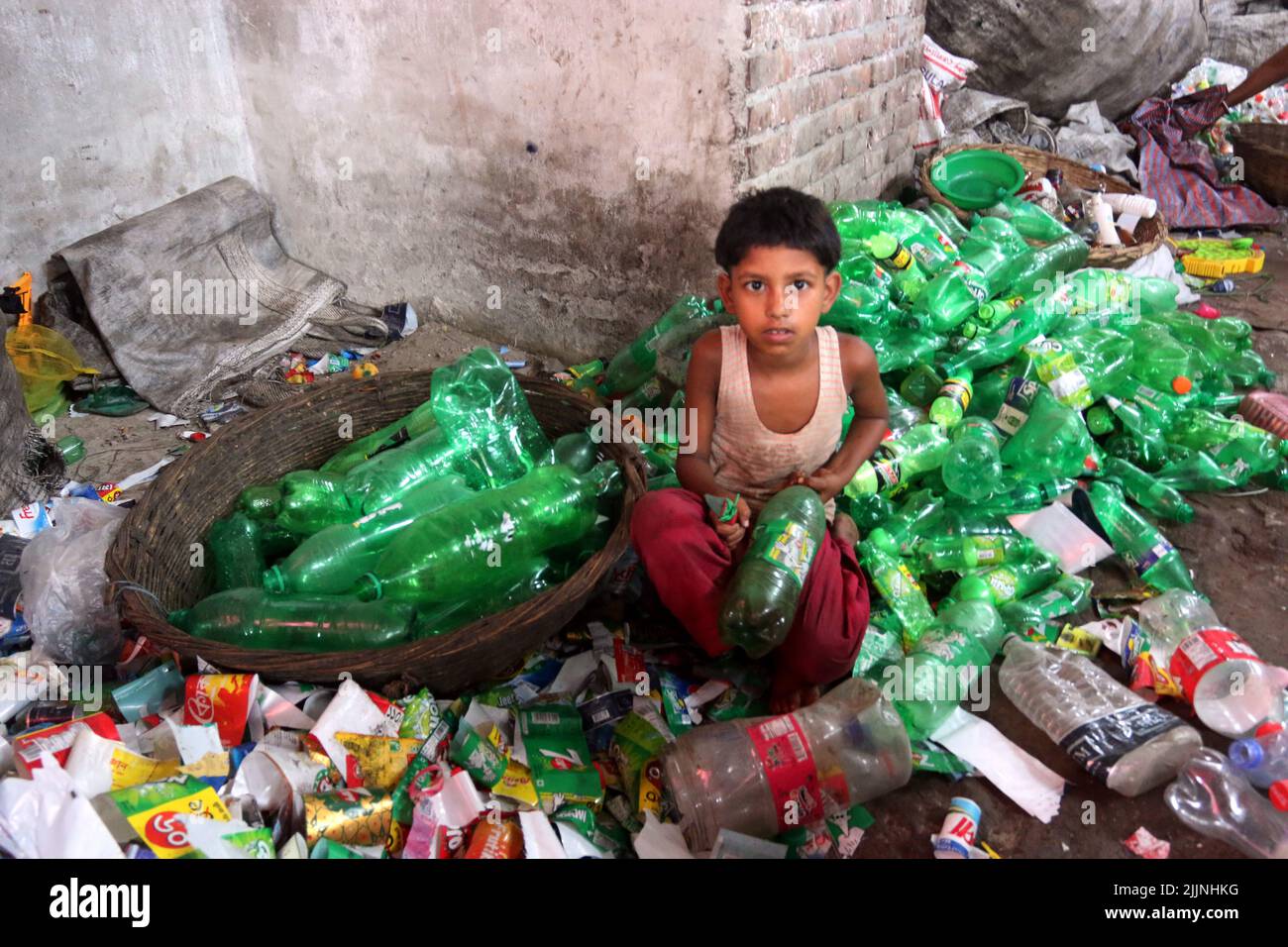 Workers are seen in a plastic bottle recycling factory in Dhaka