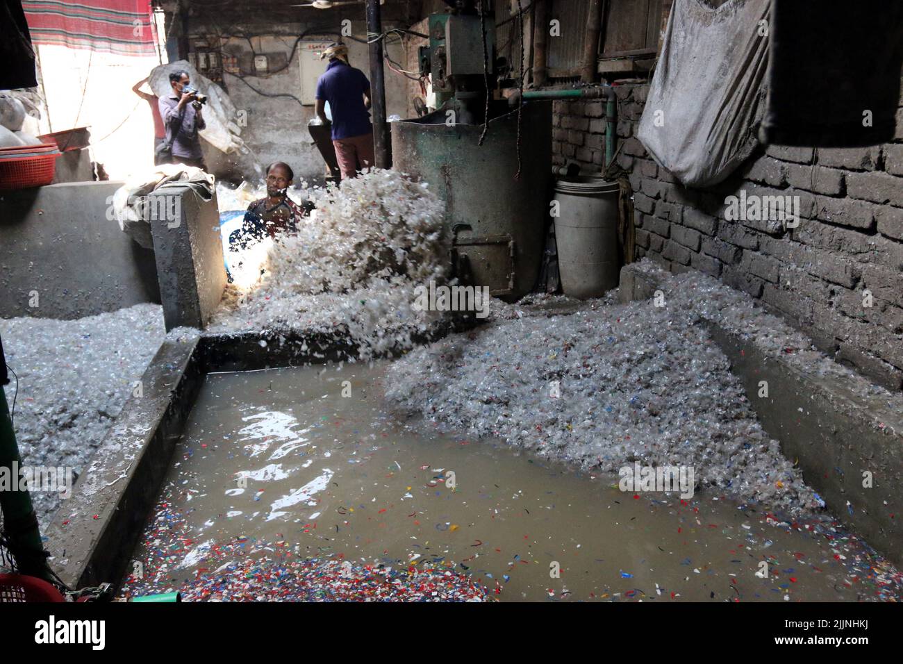 Workers are seen in a plastic bottle recycling factory in Dhaka