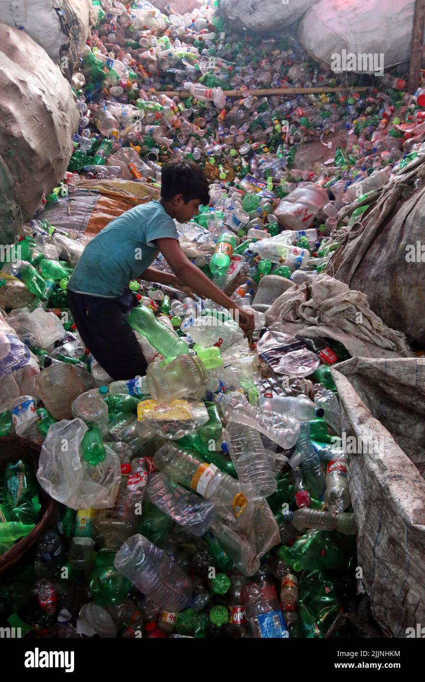Workers are seen in a plastic bottle recycling factory in Dhaka
