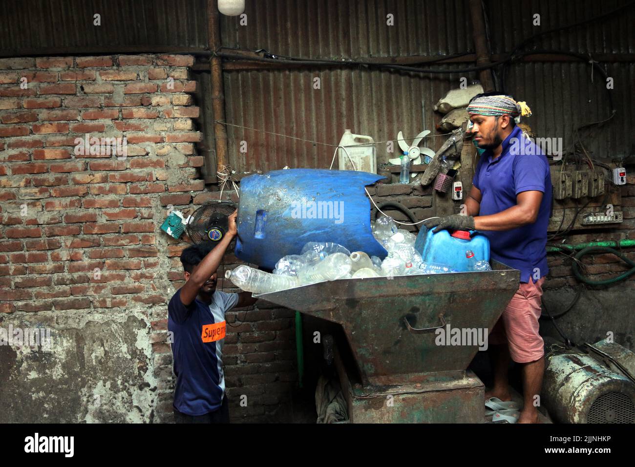 Workers are seen in a plastic bottle recycling factory in Dhaka