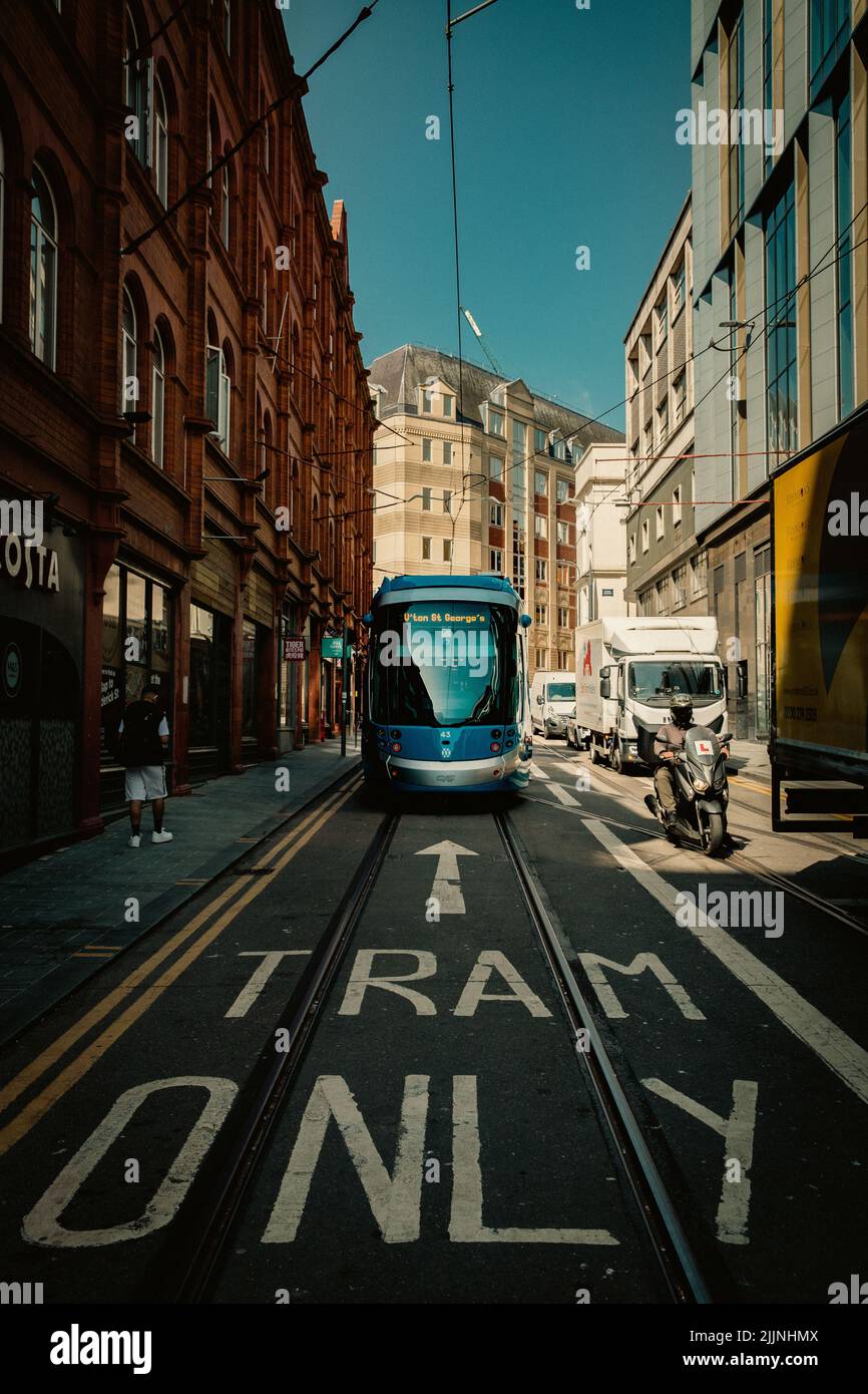 BIRMINGHAM, UK - JULY 18, 2022.  A West Midlands Metro Tram travelling along tracks on the city streets of Birmingham city centre with a Tram Only sig Stock Photo