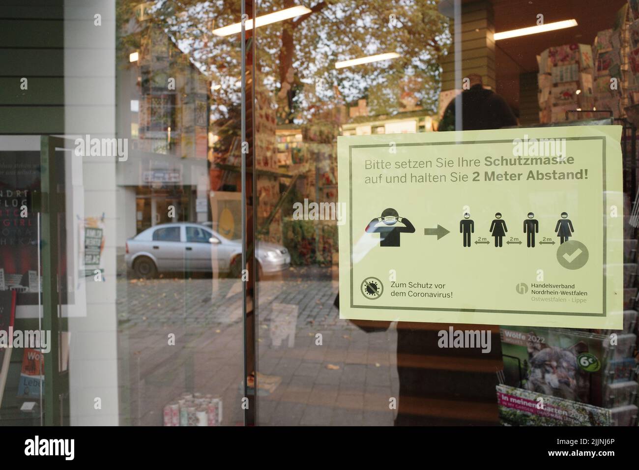 A COVID 19 code of conduct notice on a shop door in Bielefeld., Germany Stock Photo