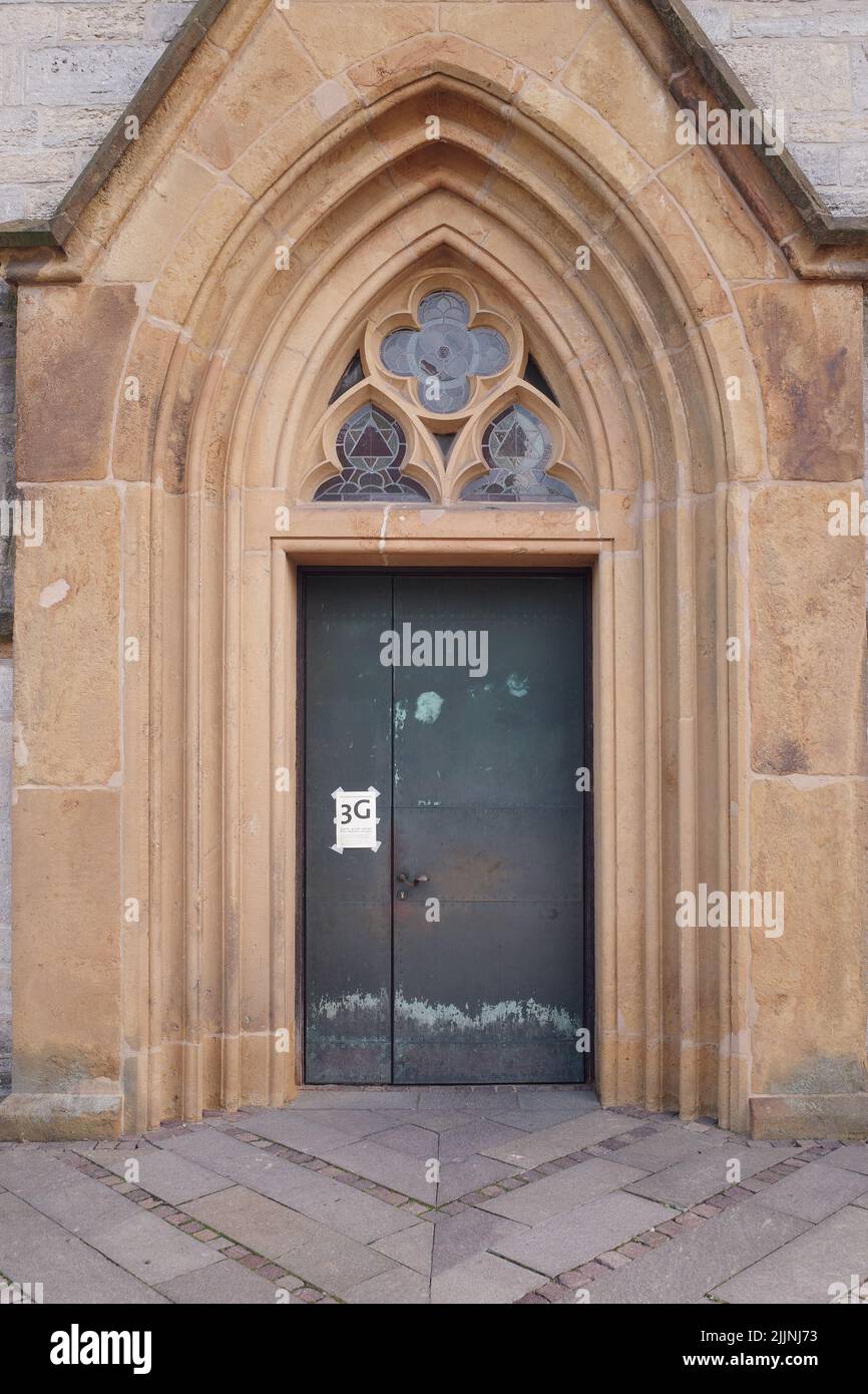 A scenic shot of a 3G notice on a church door in Bielefeld, Germany Stock Photo